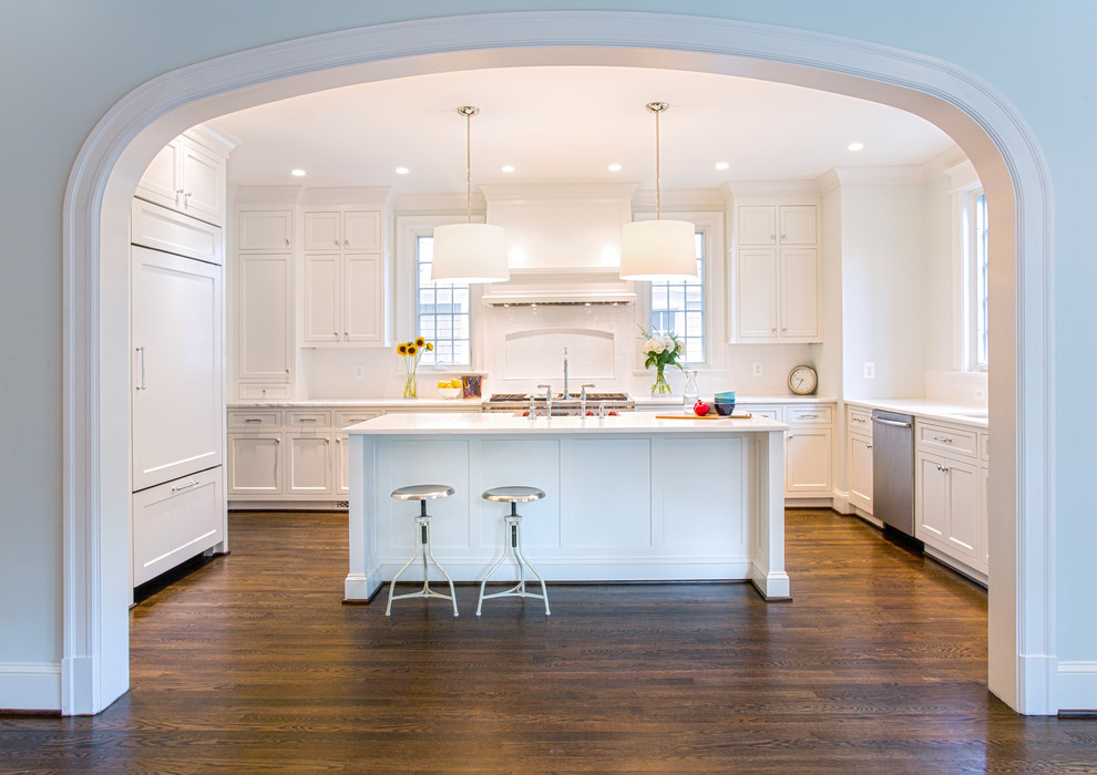 Design ideas for a mid-sized traditional u-shaped eat-in kitchen in DC Metro with marble benchtops, a farmhouse sink, beaded inset cabinets, white cabinets, ceramic splashback, stainless steel appliances and dark hardwood floors.