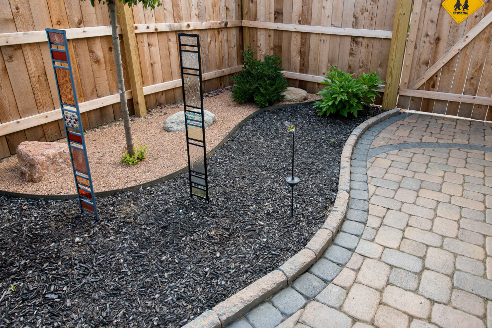 Large backyard garden in Columbus with with path and concrete pavers.
