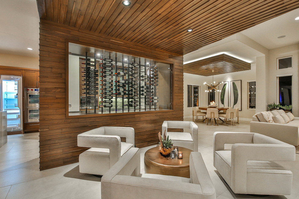 Inspiration for a mid-sized contemporary wine cellar in Other with porcelain floors, display racks and beige floor.