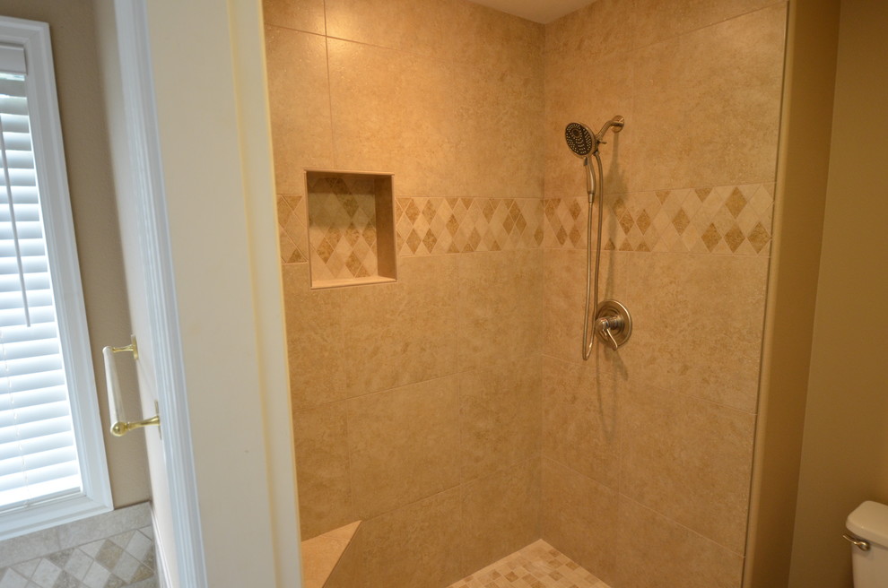 Photo of a mid-sized transitional master bathroom in Portland with engineered quartz benchtops, a drop-in tub, an alcove shower, beige tile, porcelain tile, beige walls and porcelain floors.