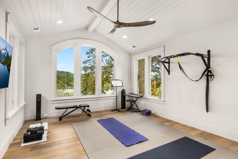 This is an example of a mid-sized transitional multipurpose gym in Portland with grey walls, light hardwood floors and timber.