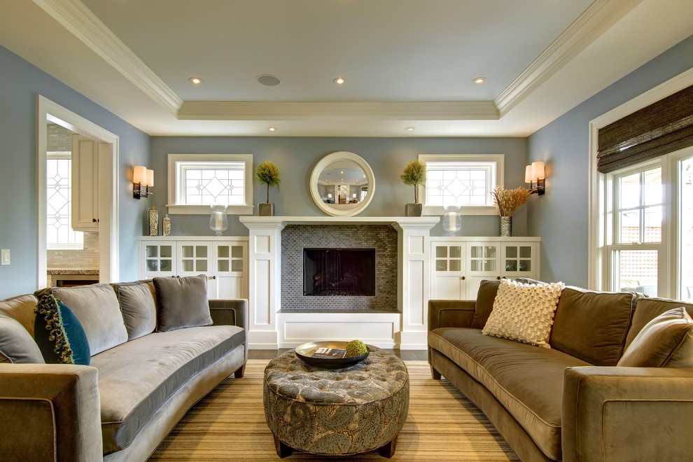 This is an example of an arts and crafts enclosed living room in Calgary with blue walls, a standard fireplace, a tile fireplace surround and no tv.