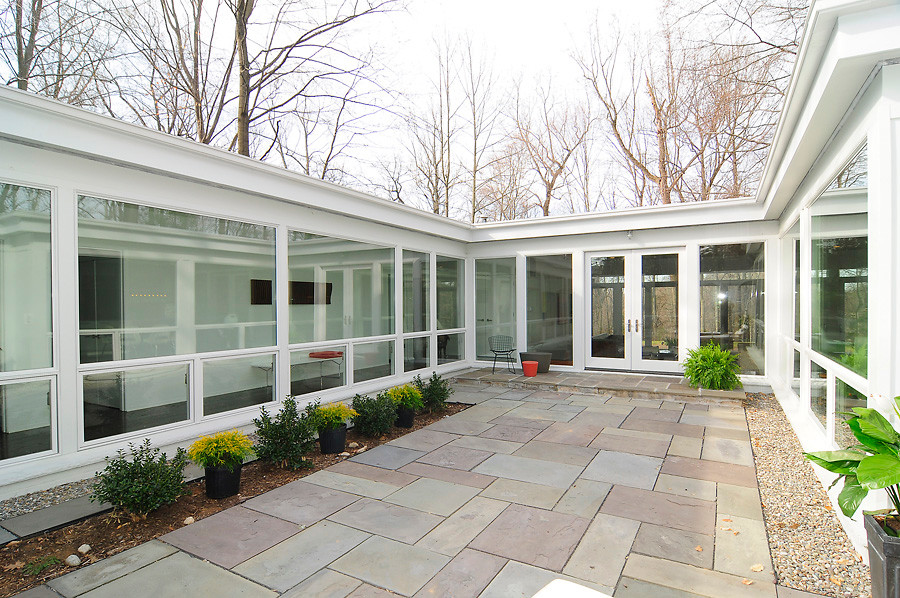 Large contemporary front door in DC Metro with white walls, concrete floors, a double front door and a glass front door.