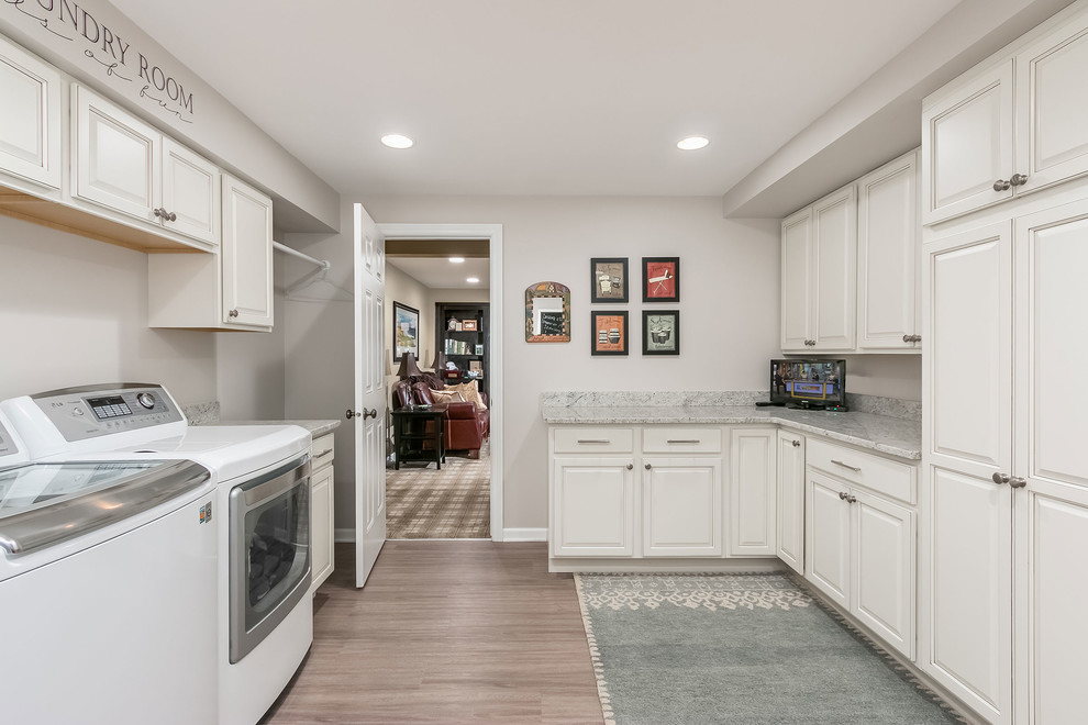Design ideas for a large traditional u-shaped dedicated laundry room in Chicago with raised-panel cabinets, white cabinets, granite benchtops, grey walls, vinyl floors, a side-by-side washer and dryer, beige floor and multi-coloured benchtop.