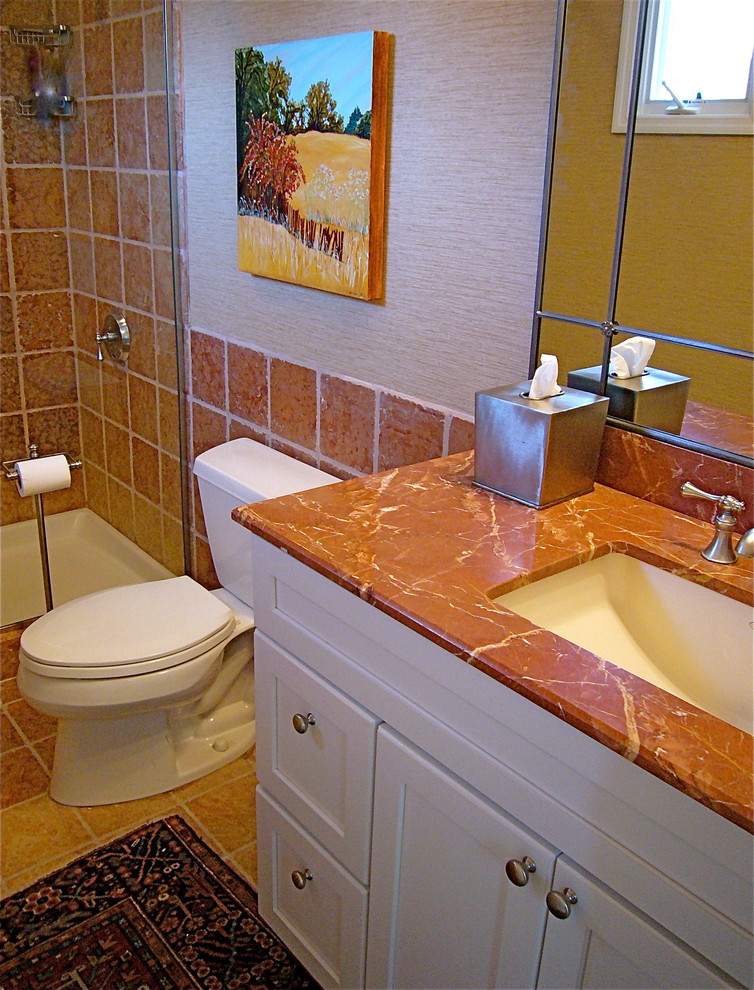 Design ideas for a mid-sized transitional bathroom in St Louis with flat-panel cabinets, dark wood cabinets, a one-piece toilet, gray tile, stone slab, white walls, an undermount sink and granite benchtops.