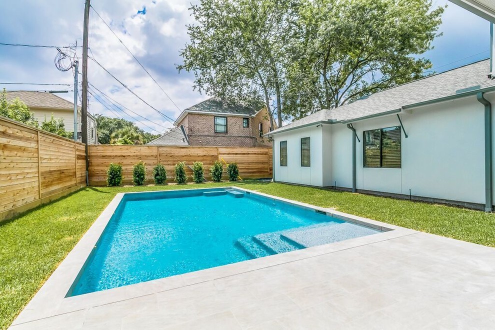 Transitional backyard concrete paver and rectangular lap pool photo in Houston