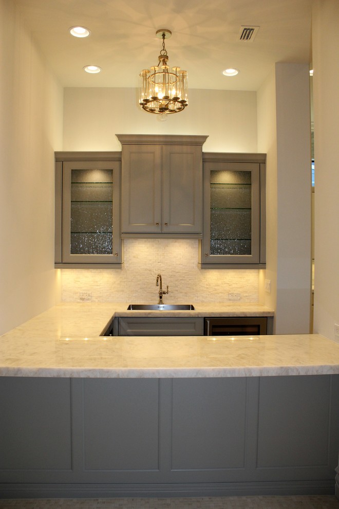 Large transitional galley porcelain tile eat-in kitchen photo in Tampa with an undermount sink, shaker cabinets, white cabinets, quartzite countertops, multicolored backsplash, glass sheet backsplash, stainless steel appliances and two islands