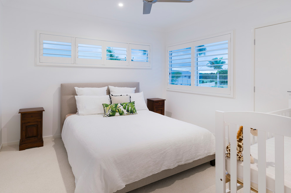 Photo of a small beach style guest bedroom in Gold Coast - Tweed with white walls, carpet and beige floor.