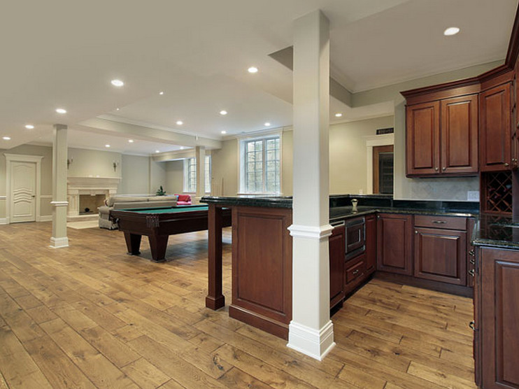 Inspiration for a transitional walk-out carpeted basement remodel in Chicago with beige walls, a standard fireplace and a stone fireplace