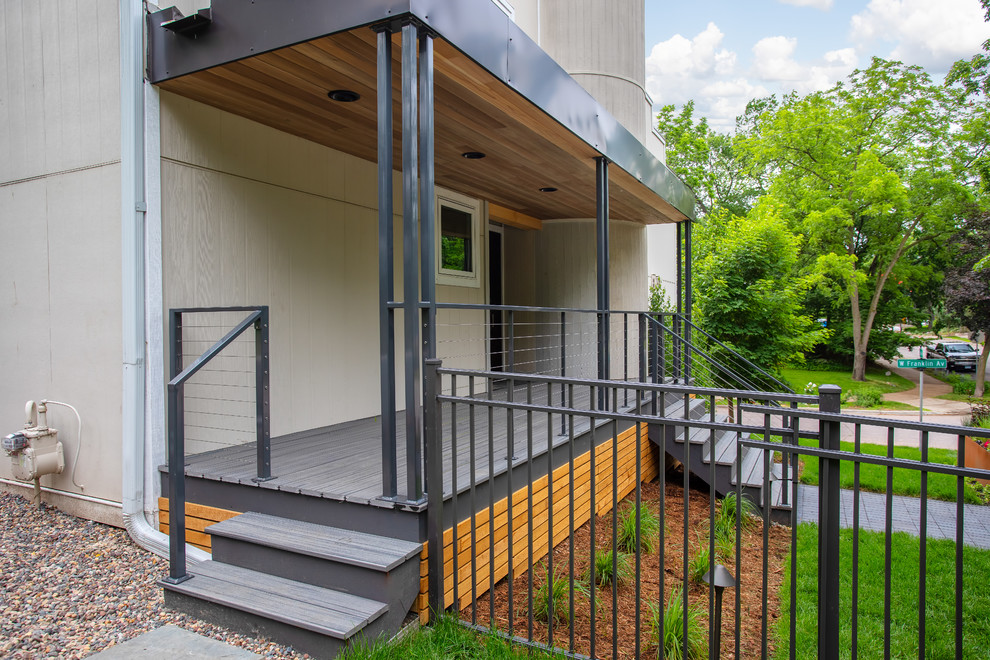 Mid-sized modern front yard verandah in Minneapolis with decking and an awning.