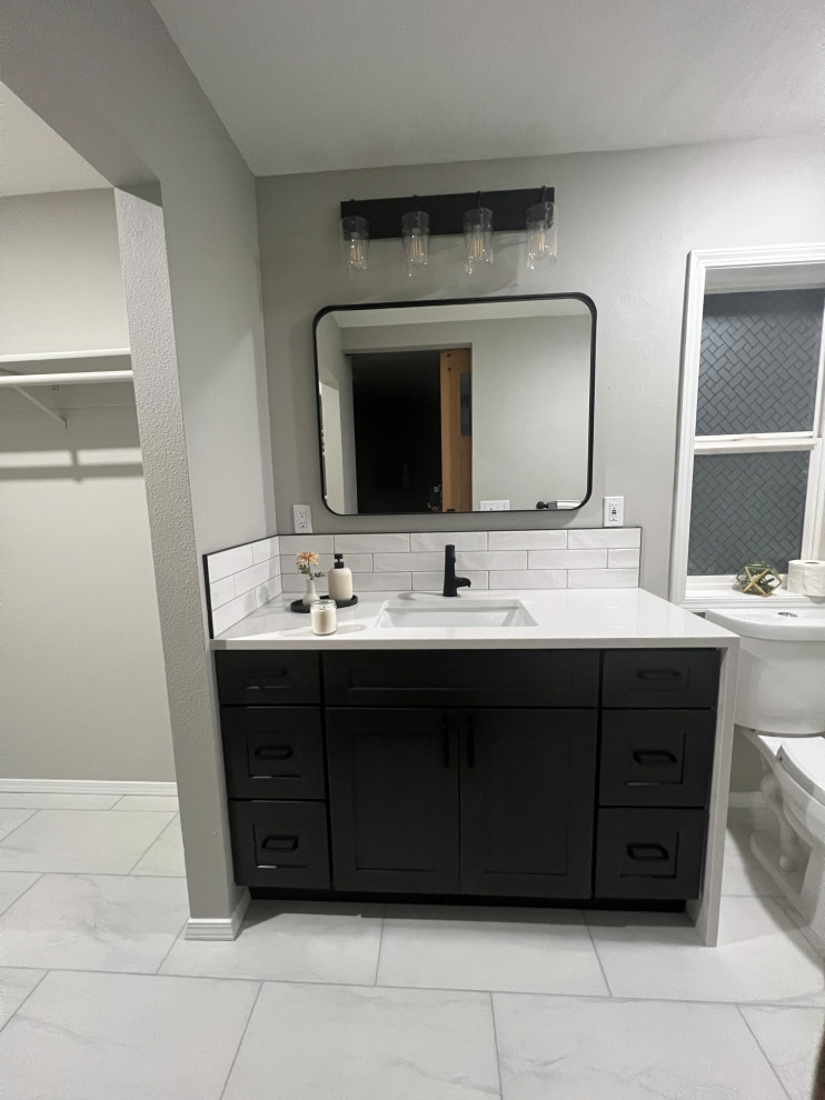 This is an example of a mid-sized modern master bathroom with shaker cabinets, black cabinets, an alcove shower, a two-piece toilet, white tile, ceramic tile, grey walls, porcelain floors, an undermount sink, quartzite benchtops, white floor, a sliding shower screen, white benchtops, an enclosed toilet, a single vanity, a freestanding vanity and coffered.