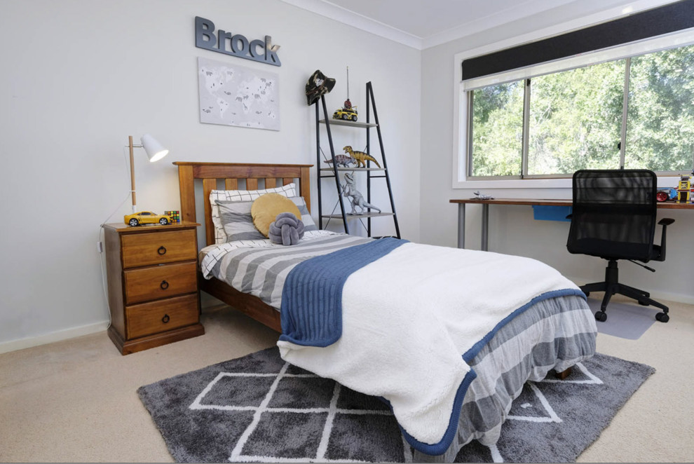 Design ideas for a mid-sized contemporary kids' study room for kids 4-10 years old and boys in Other with white walls, carpet and beige floor.