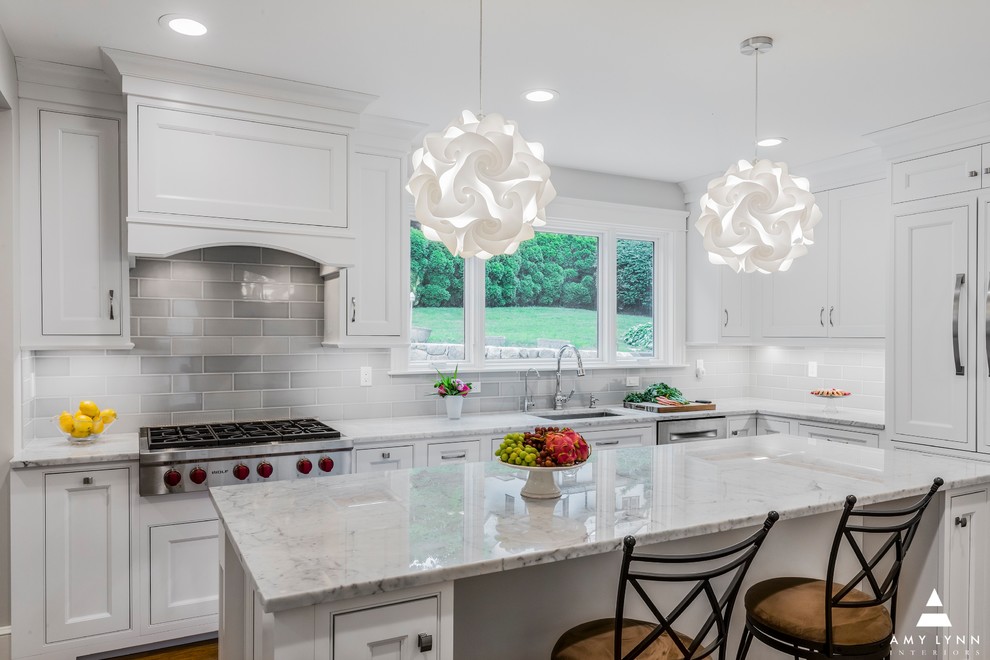 Inspiration for a mid-sized transitional l-shaped medium tone wood floor and red floor eat-in kitchen remodel in Boston with an undermount sink, beaded inset cabinets, white cabinets, marble countertops, gray backsplash, porcelain backsplash, paneled appliances, an island and yellow countertops