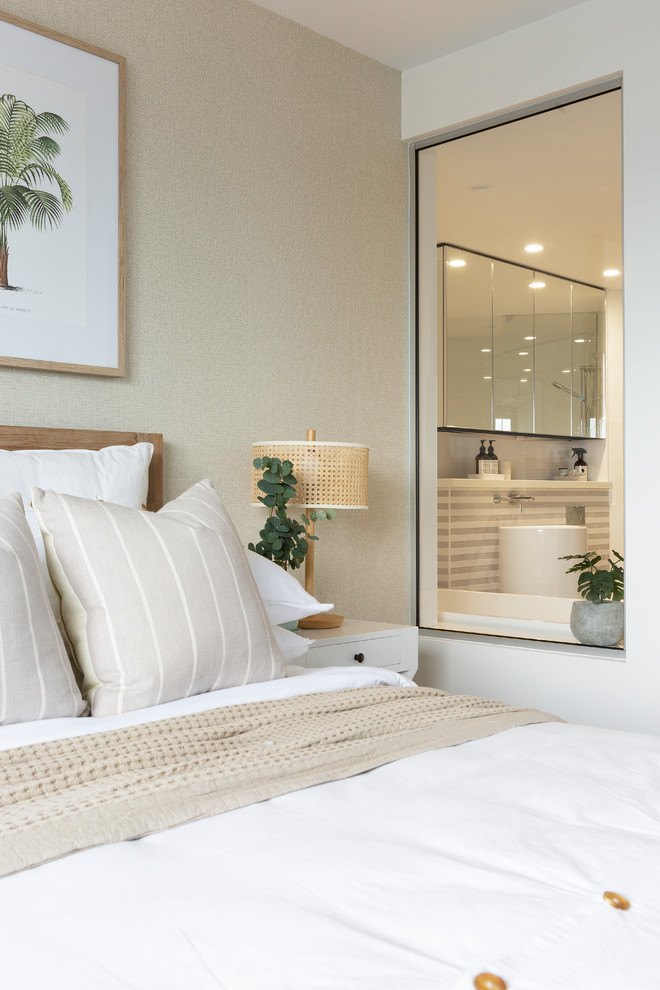 Mid-sized beach style guest bedroom in Gold Coast - Tweed with beige walls, carpet and beige floor.