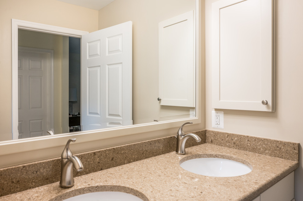 This is an example of a mid-sized traditional master bathroom in DC Metro with recessed-panel cabinets, white cabinets, beige walls, ceramic floors, an undermount sink, granite benchtops, beige floor, beige benchtops, a niche, a double vanity and a floating vanity.