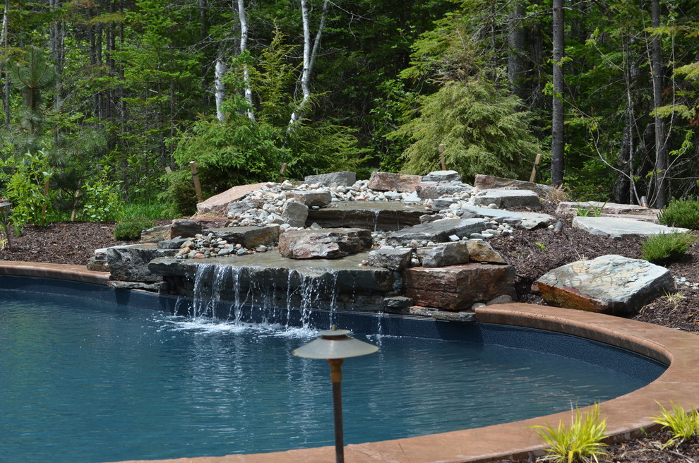 Pool - large rustic backyard stamped concrete and freeform natural pool idea