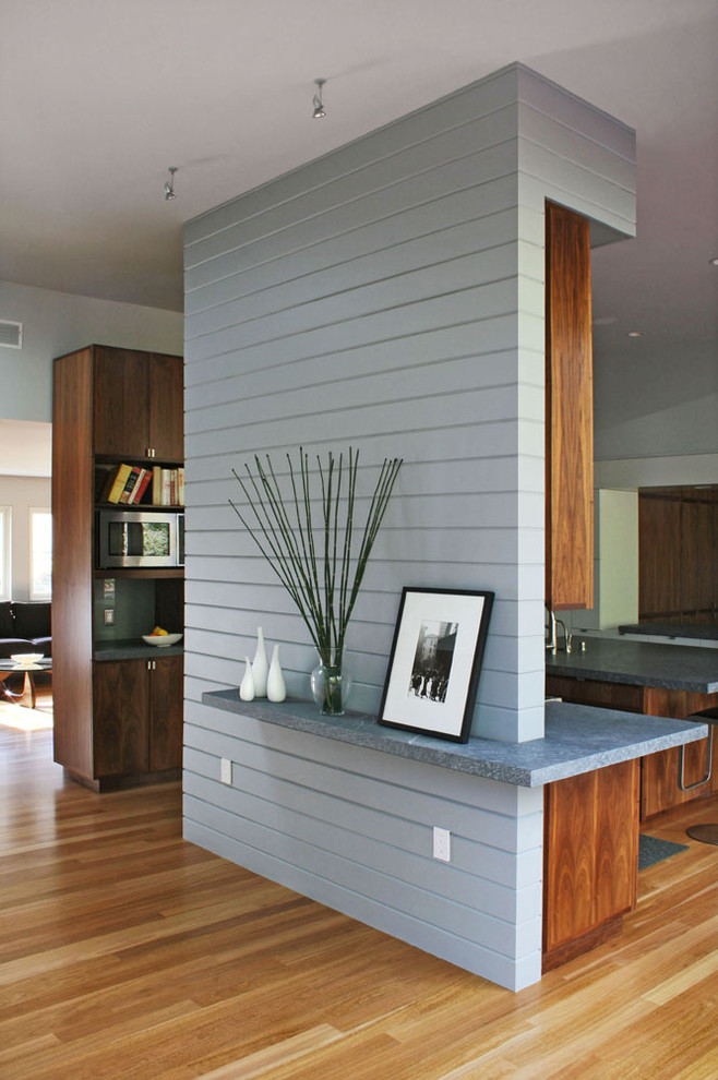 This is an example of a transitional kitchen/dining combo in San Francisco with grey walls and light hardwood floors.