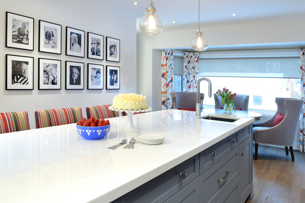 Eat-in kitchen - mid-sized transitional single-wall dark wood floor and brown floor eat-in kitchen idea in Toronto with a double-bowl sink, shaker cabinets, white cabinets, quartz countertops, gray backsplash, stainless steel appliances, an island and white countertops