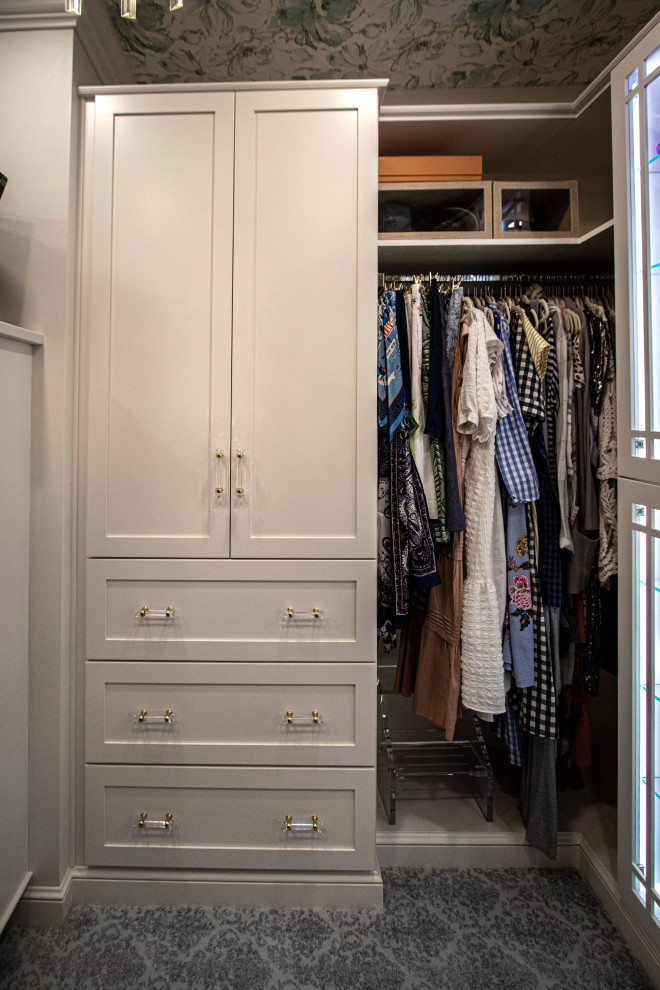 Photo of a mid-sized traditional women's walk-in wardrobe in Cleveland with flat-panel cabinets, white cabinets, carpet, grey floor and wallpaper.