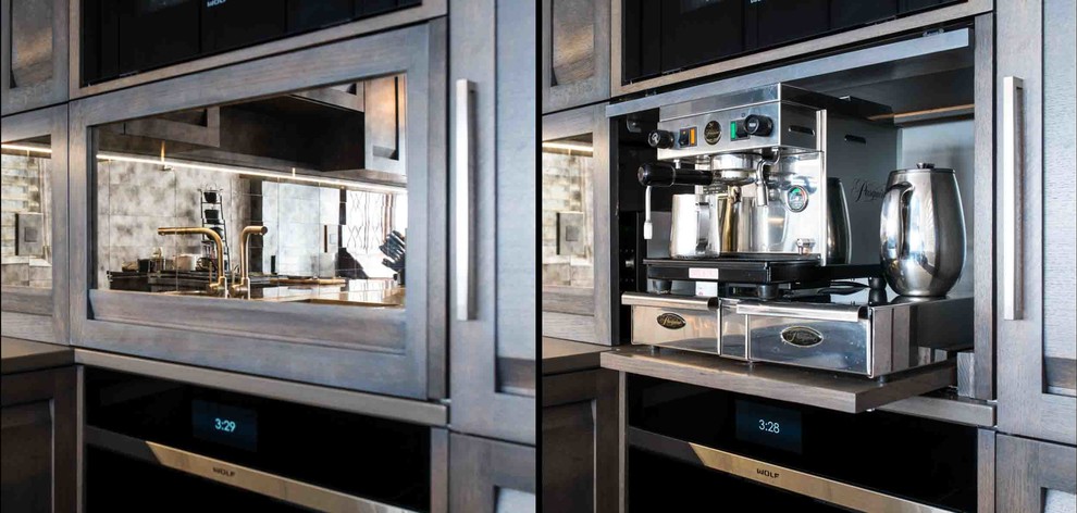 Inspiration for a mid-sized rustic u-shaped dark wood floor and brown floor home design remodel in Chicago with an undermount sink, flat-panel cabinets, gray cabinets, quartz countertops, metallic backsplash, mirror backsplash, paneled appliances and a peninsula