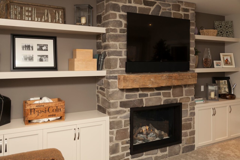 Transitional carpeted basement photo in Toronto with gray walls, a standard fireplace and a stone fireplace