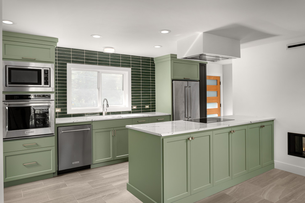 Inspiration for a mid-sized midcentury galley eat-in kitchen in Portland with an undermount sink, shaker cabinets, green cabinets, quartz benchtops, green splashback, cement tile splashback, stainless steel appliances, porcelain floors, a peninsula, grey floor and multi-coloured benchtop.