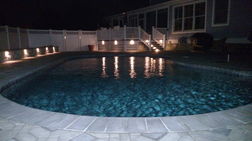 Example of a large classic backyard stone and kidney-shaped pool design