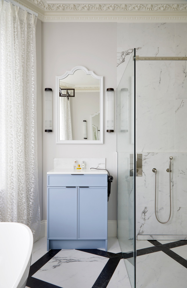 Inspiration for a medium sized contemporary cream and black family bathroom in London with blue cabinets, a freestanding bath, a walk-in shower, white walls, a built-in sink, multi-coloured floors, a hinged door, white worktops, a single sink, a built in vanity unit and a coffered ceiling.