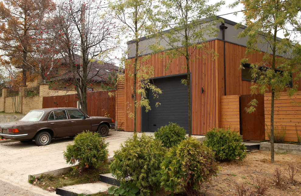 Design ideas for a mid-sized contemporary detached one-car garage in Moscow.