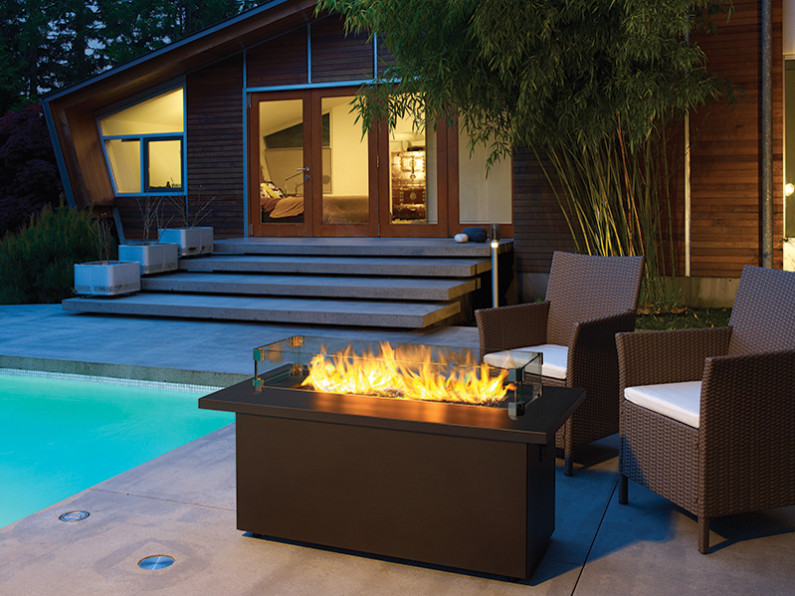 Photo of a large modern courtyard patio in Bridgeport with a fire feature, concrete slab and no cover.