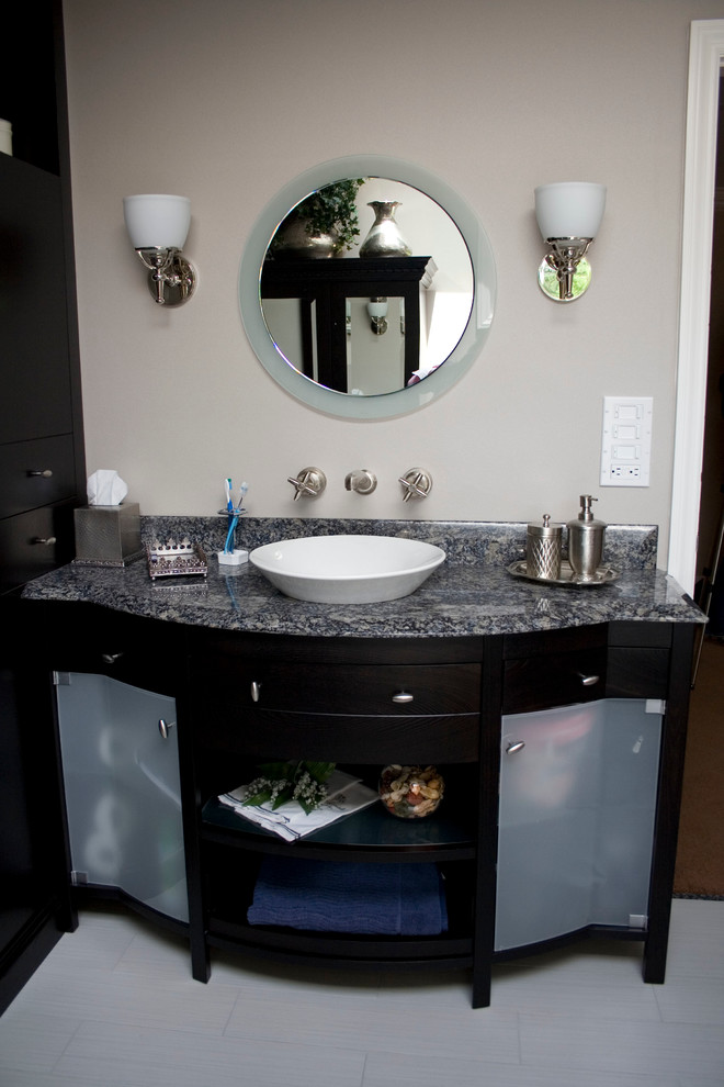 Photo of a large contemporary master bathroom in New York with a vessel sink, glass-front cabinets, black cabinets, laminate benchtops, grey walls and ceramic floors.