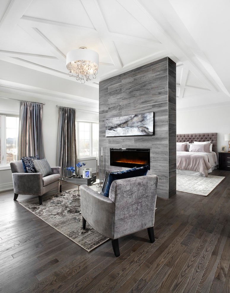 Inspiration for a transitional bedroom in Toronto with white walls, dark hardwood floors, a ribbon fireplace and brown floor.