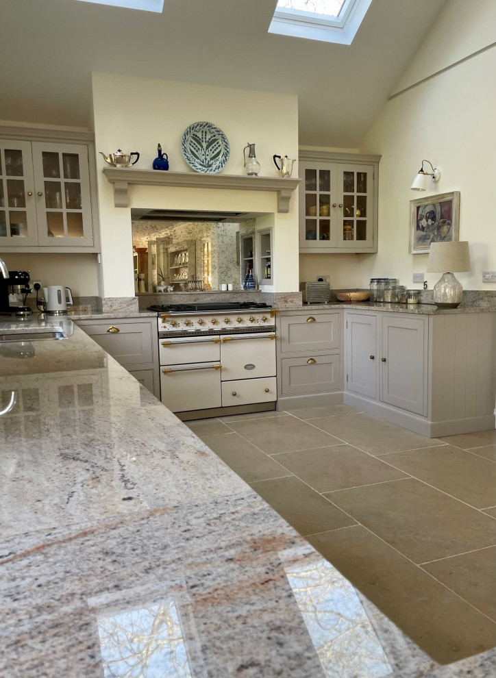 Medium sized traditional kitchen in Surrey with a built-in sink, beaded cabinets, grey cabinets, metallic splashback and mirror splashback.