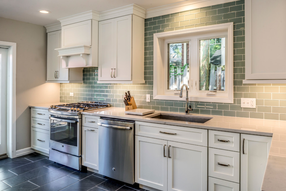 This is an example of a transitional l-shaped kitchen in Chicago with an undermount sink, shaker cabinets and white cabinets.