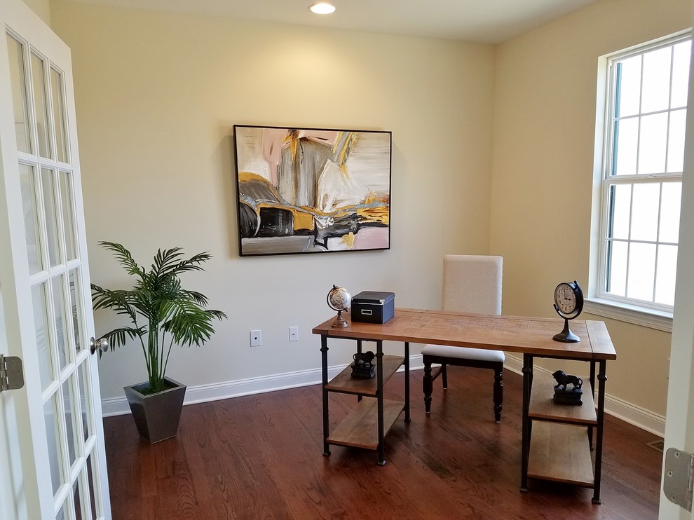Photo of a small transitional study room in Philadelphia with grey walls and dark hardwood floors.