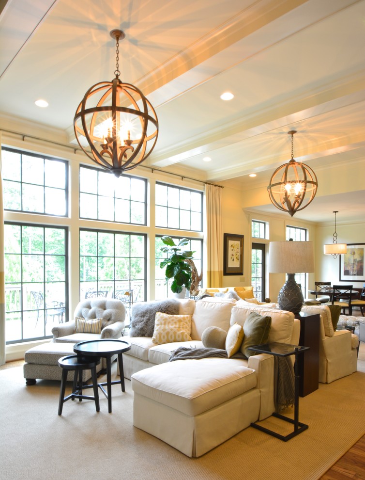 Design ideas for a large transitional open concept living room in Atlanta with white walls, medium hardwood floors, a standard fireplace, a stone fireplace surround and a wall-mounted tv.