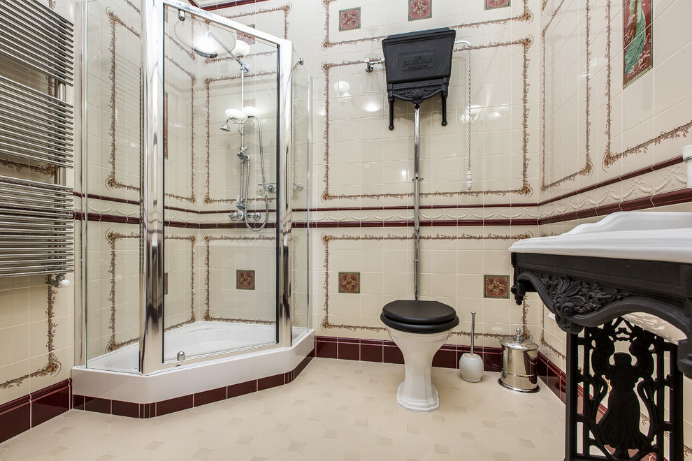 This is an example of a traditional bathroom in Other with a corner shower, a two-piece toilet, beige tile, multi-coloured tile and a pedestal sink.