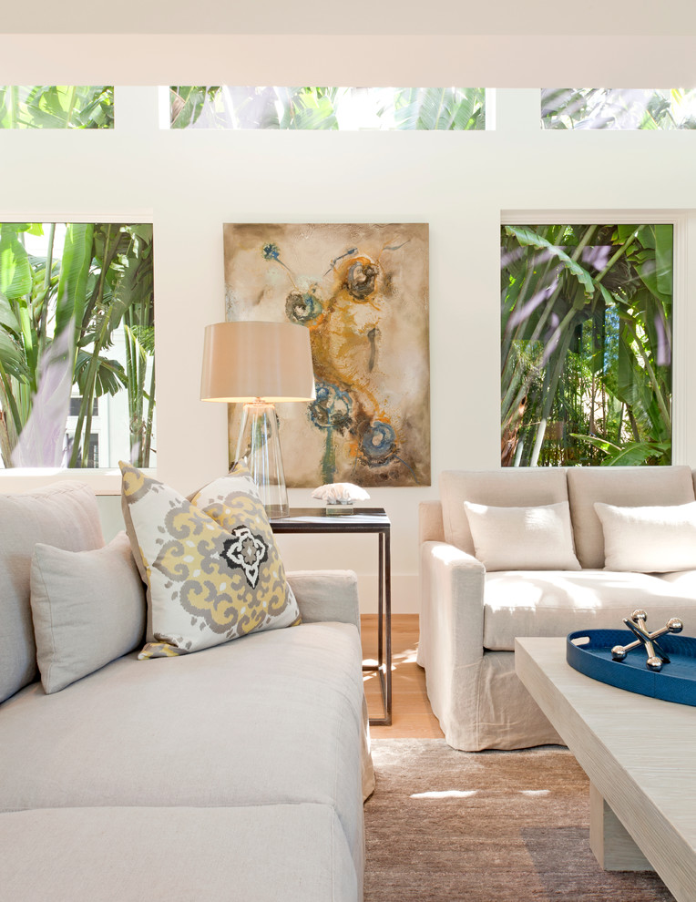 Transitional formal living room in Miami with white walls and light hardwood floors.