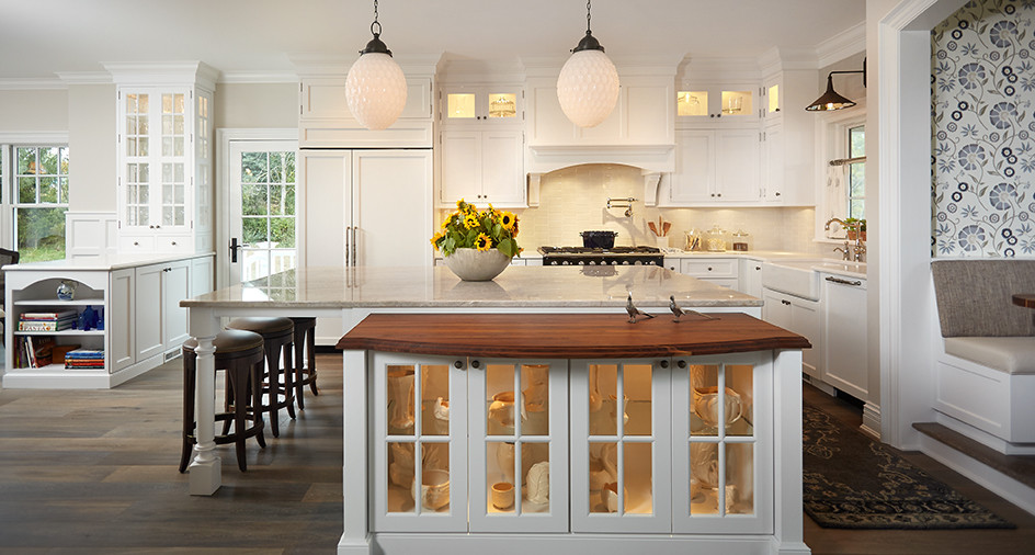Inspiration for a large traditional l-shaped eat-in kitchen in Grand Rapids with a farmhouse sink, shaker cabinets, white cabinets, granite benchtops, white splashback, ceramic splashback, panelled appliances, dark hardwood floors, with island and grey floor.