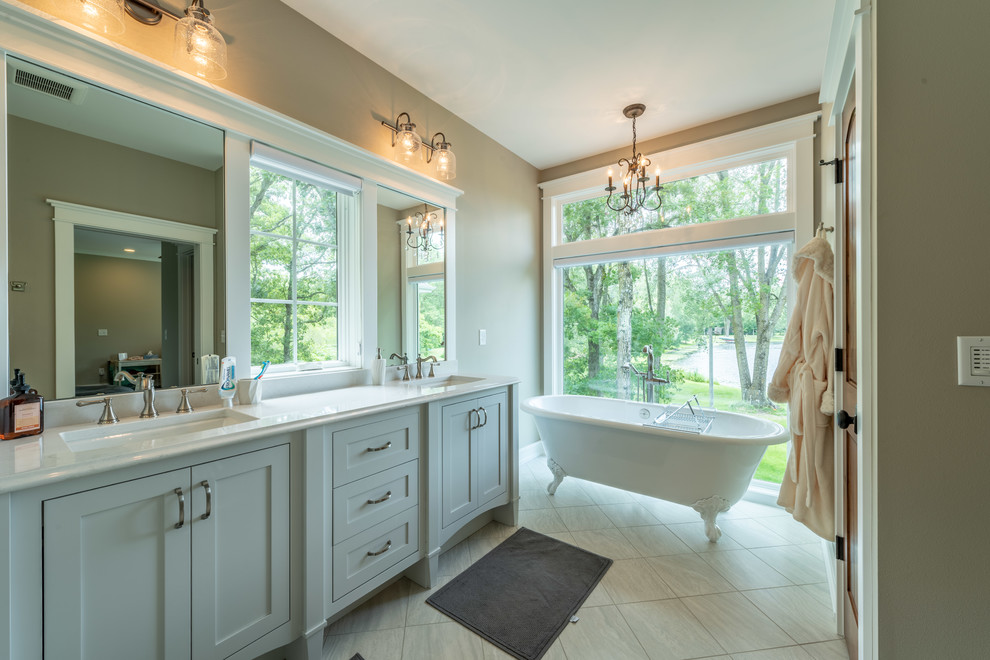 Mid-sized arts and crafts master bathroom in Milwaukee with beaded inset cabinets, grey cabinets, a claw-foot tub, a corner shower, a two-piece toilet, beige walls, ceramic floors, an undermount sink, engineered quartz benchtops, white floor, a hinged shower door and yellow benchtops.