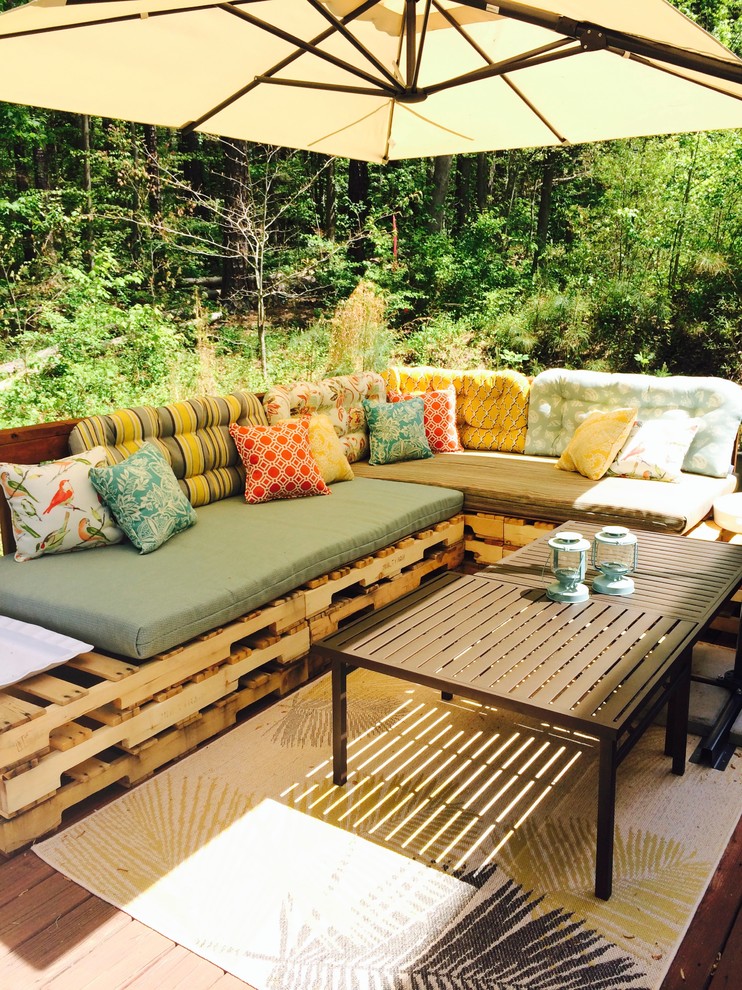 Photo of a mid-sized tropical backyard deck in Raleigh.