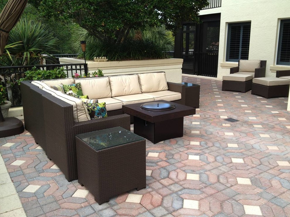 Photo of an expansive contemporary backyard patio in Orlando with a fire feature, brick pavers and no cover.