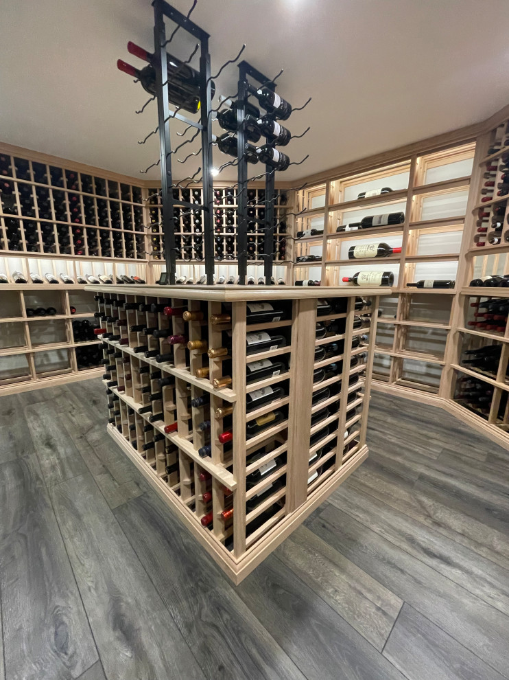 Inspiration for a large traditional wine cellar in Cincinnati with laminate floors, display racks and grey floor.