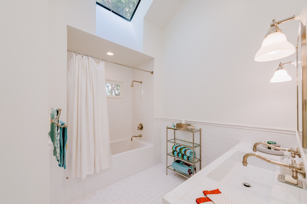 Photo of a mid-sized transitional bathroom in Los Angeles with an alcove tub, a shower/bathtub combo, white tile, subway tile, white walls, porcelain floors, tile benchtops, white floor and a shower curtain.