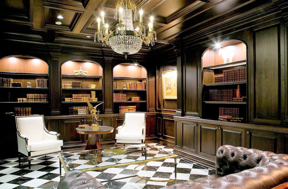 Design ideas for a large traditional home office in New York with a library, ceramic floors, a standard fireplace, a stone fireplace surround, a freestanding desk, white floor and brown walls.