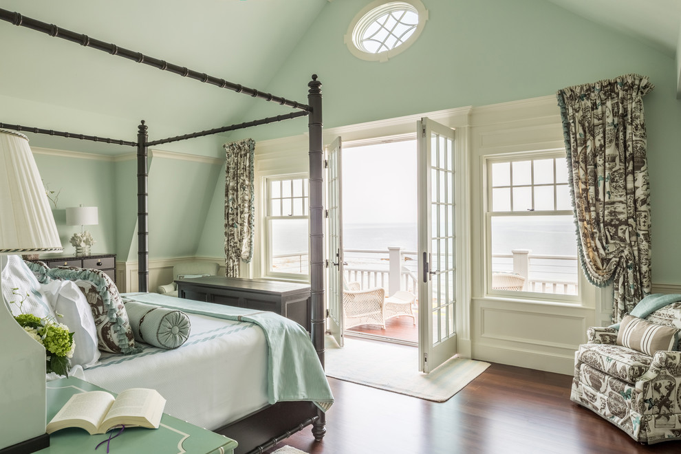 Photo of a beach style bedroom in Portland Maine with green walls, dark hardwood floors and brown floor.