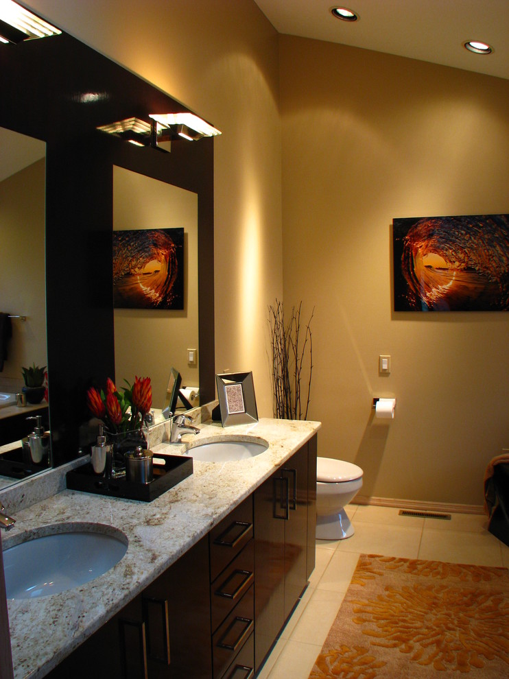 Example of a mid-sized transitional 3/4 ceramic tile and beige floor bathroom design in Indianapolis with flat-panel cabinets, dark wood cabinets, a two-piece toilet, beige walls and an undermount sink
