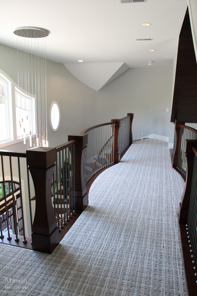 Large transitional wooden curved wood railing, dark wood floor and vaulted ceiling double front door photo with painted risers, gray walls and a dark wood front door