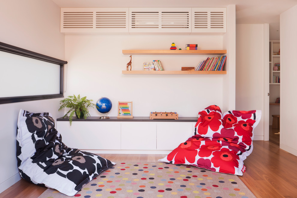 Design ideas for a contemporary gender-neutral kids' playroom for kids 4-10 years old in Melbourne with white walls and light hardwood floors.