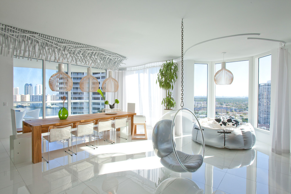 Contemporary open plan dining in Miami with white walls and no fireplace.